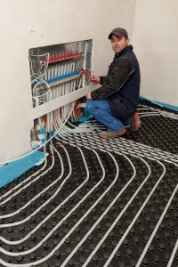 in floor heating and cooling, man work on building site